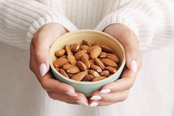 vegan protein food closeup. brown nuts in light background. vegan protein food closeup. brown nuts in light background.