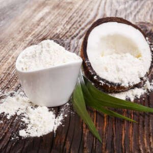 fresh coconut flour raw coconut half on wooden table. healthy coconut eating.