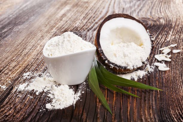 fresh coconut flour raw coconut half on wooden table. healthy coconut eating. fresh coconut flour raw coconut half on wooden table. healthy coconut eating.