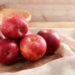 group of gala apple on wooden board background, fruits concept.