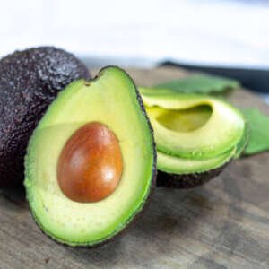 two fresh ripe raw hass avocados, close up, healthy food concept