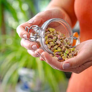 woman eating fresh organic pistachios