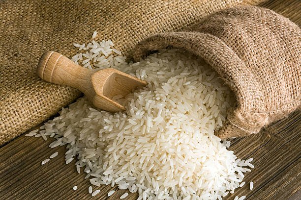 white uncooked rice in small burlap sack white uncooked rice in small burlap sack