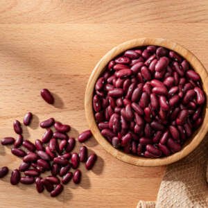 bowl filled with raw red kidney beans shot from above on wooden table