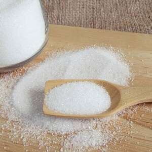 white sugar in wood spoon