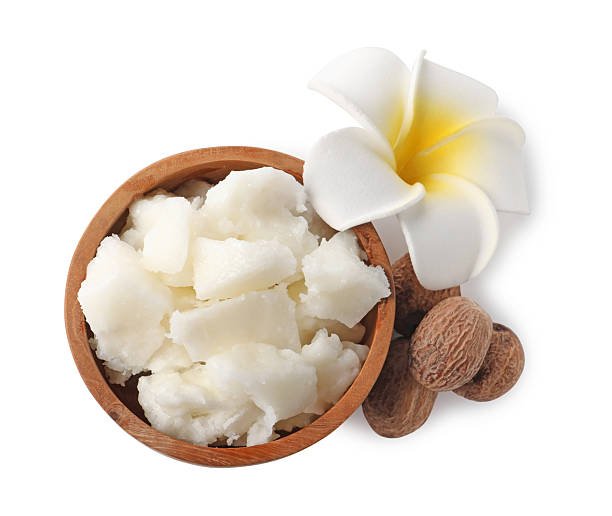 natural shea butter, nuts and plumeria flower isolated on white, top view natural shea butter, nuts and plumeria flower isolated on white, top view