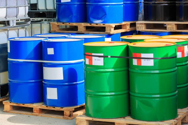 big green and blue barrels standing on wooden pallets on a chemical plant big green and blue barrels standing on wooden pallets on a chemical plant