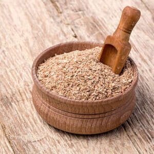 wheat bran in a small wooden bowl close up background